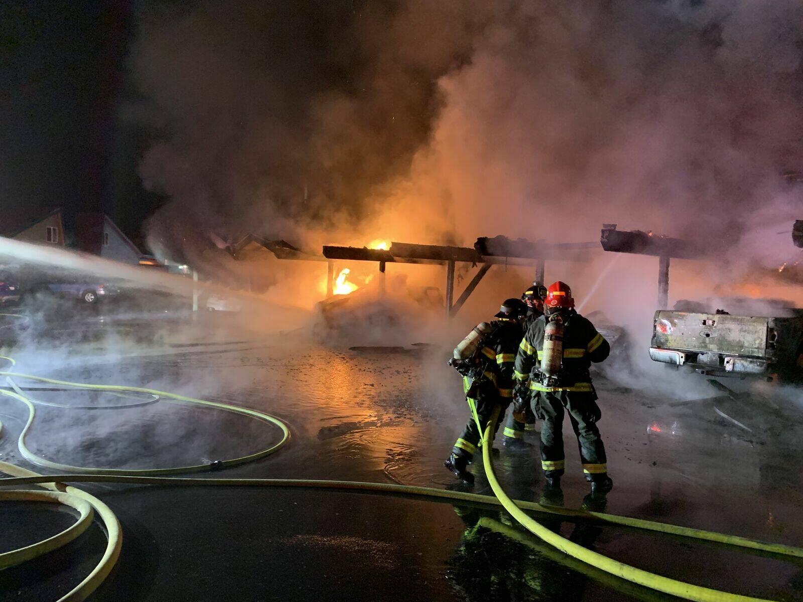 Firefighters spray water at a carport engulfed in flames at the Riverfront Apartment complex on 8th Street Southeast. The apartment complex was engulfed in a three-alarm fire Nov. 7. Photo courtesy of Valley Regional Fire Authority