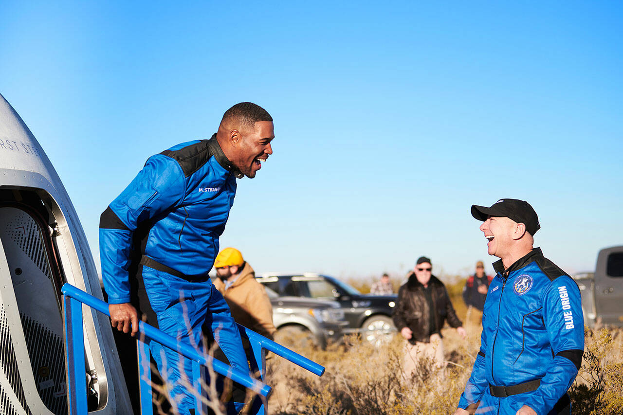 COURTESY PHOTO, Blue Origin
Michael Strahan walks off the New Shepard capsule Dec. 11 in West Texas and is greeted by Blue Origin founder Jeff Bezos after his 10-minute flight into space.