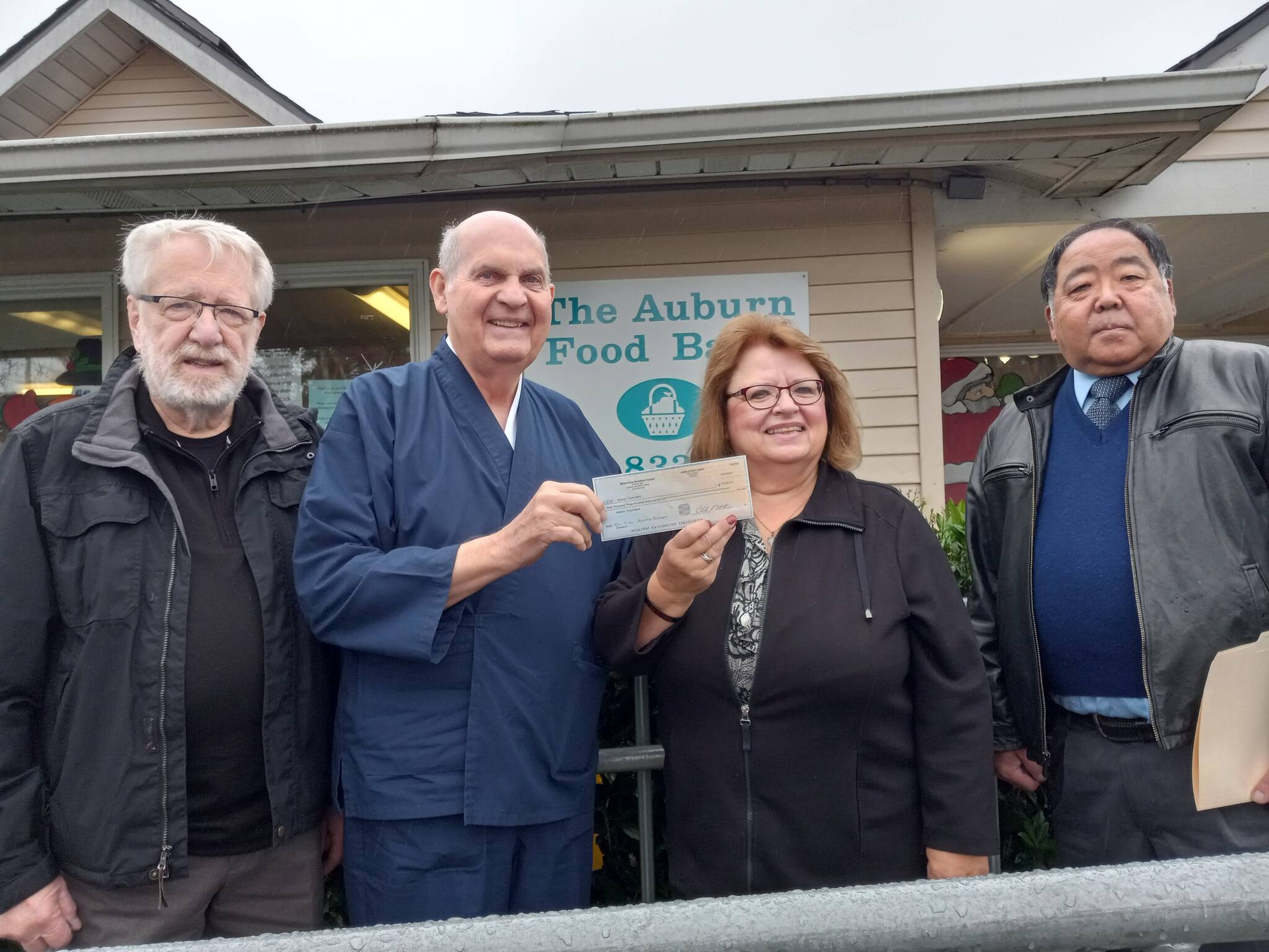 Photo by Robert Whale, Auburn Reporter
From left: Don Gardner, White River Buddhist Temple Sensei Jim Warrick, Randy Nakamoto present a $9,360 check to Debbie Christian, director of the Auburn Food Bank.