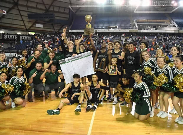 Auburn High School boys basketball team poses for a photo after winning the state championship game against Rainier Beach. Photo courtesy of Auburn High School basketball.