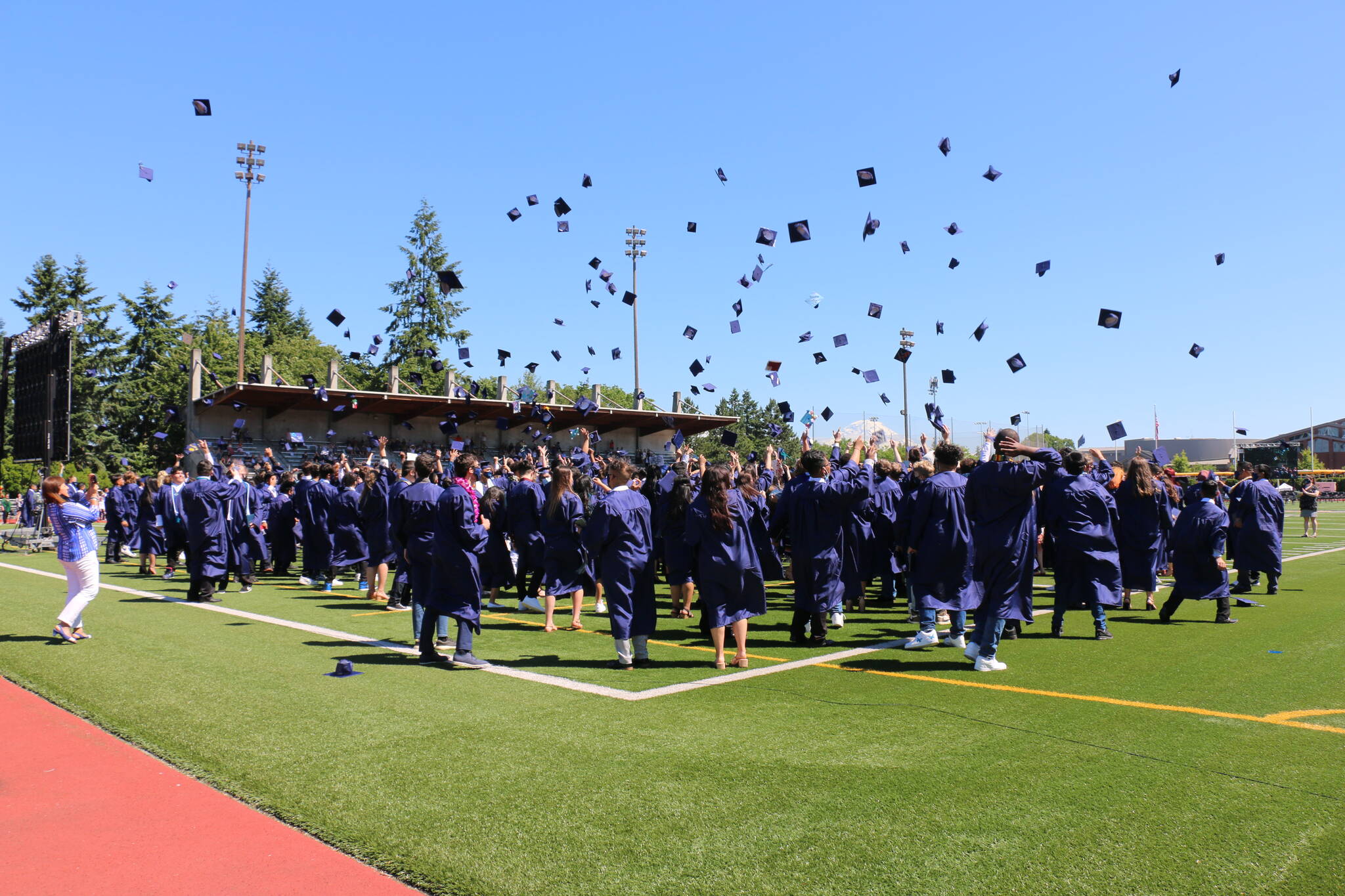 Auburn Riverside High School graduates toss their caps into the air in celebration during graduation ceremonies in 2021. Courtesy photo