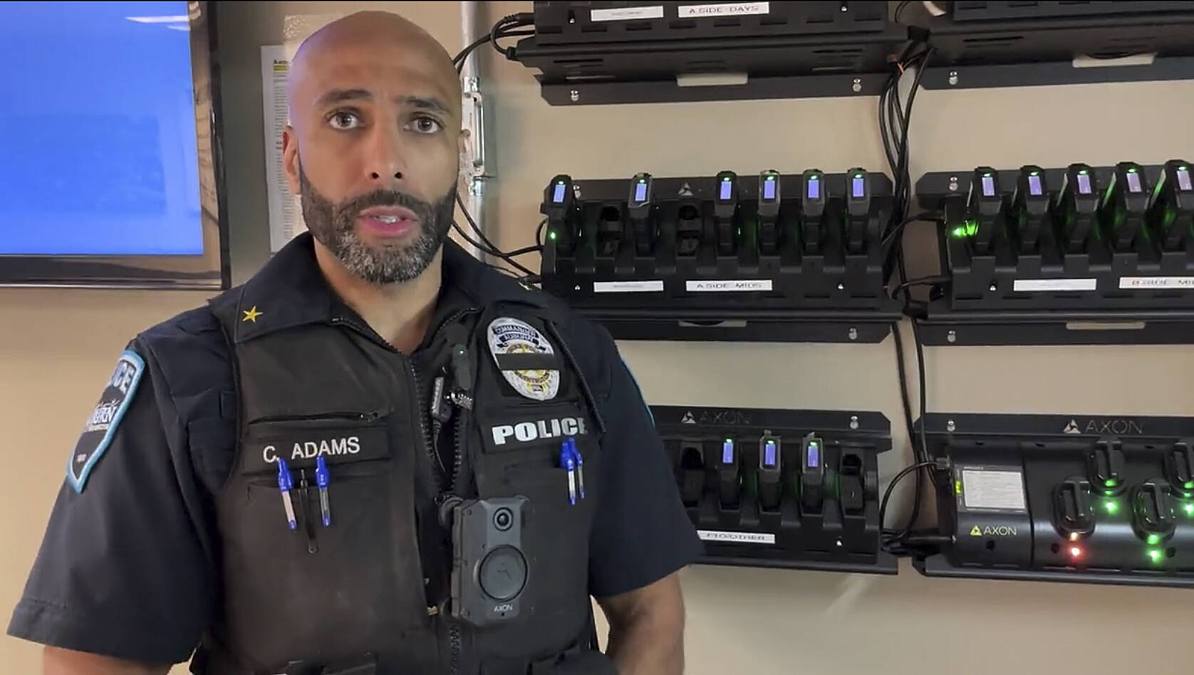 Cmdr. Adams of the Auburn Police Department demonstrates how to use the body-worn cameras. Screenshot courtesy of APD Twitter video