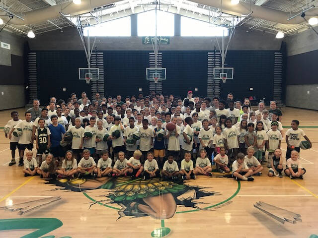 Photo of camp instructors and atendees from a previous camp. Photo courtesy of Auburn Hoops.