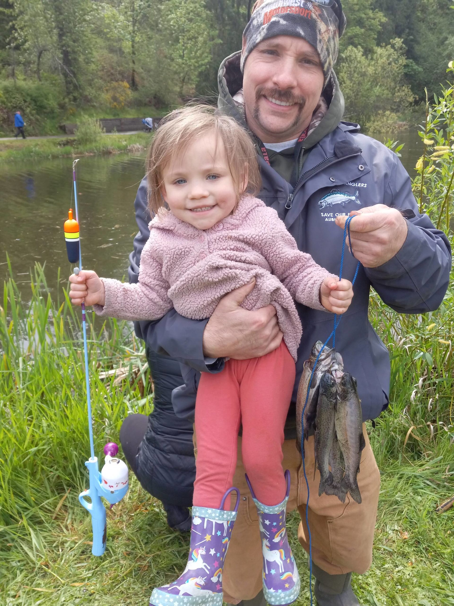 Photo by Robert Whale, Auburn Reporter
Isabel Palady, all of 2 years old, displays the first fish she has ever caught, at the 60th annual fishing derby at Mill Creek Pond last Saturday.