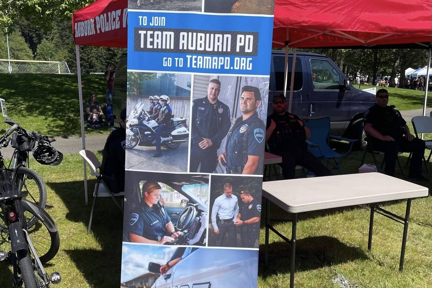 Photo of promotional recruitment banner used by Auburn Police Department at Petpalooza. The banner features Auburn Police Officer Jeff Nelson, who is awaiting trial for the 2019 murder and assault of Jesse Sarey. Photo courtesy of Jeff Trimble