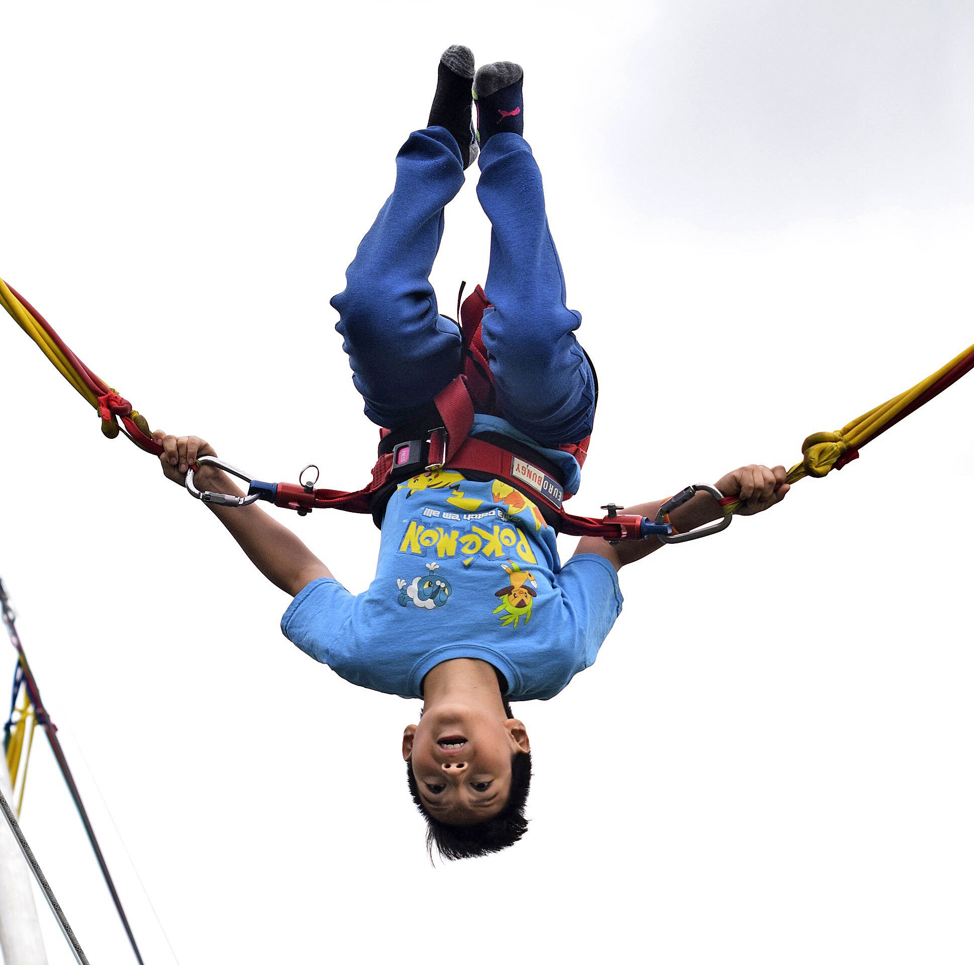 Christian Cordova does flips on the bungie trampoline at the 2019 Kids Day. File photo