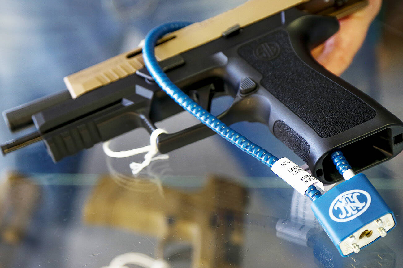 A semiautomatic handgun with a safety cable lock that prevents loading ammunition. (Sound Publishing file photo)