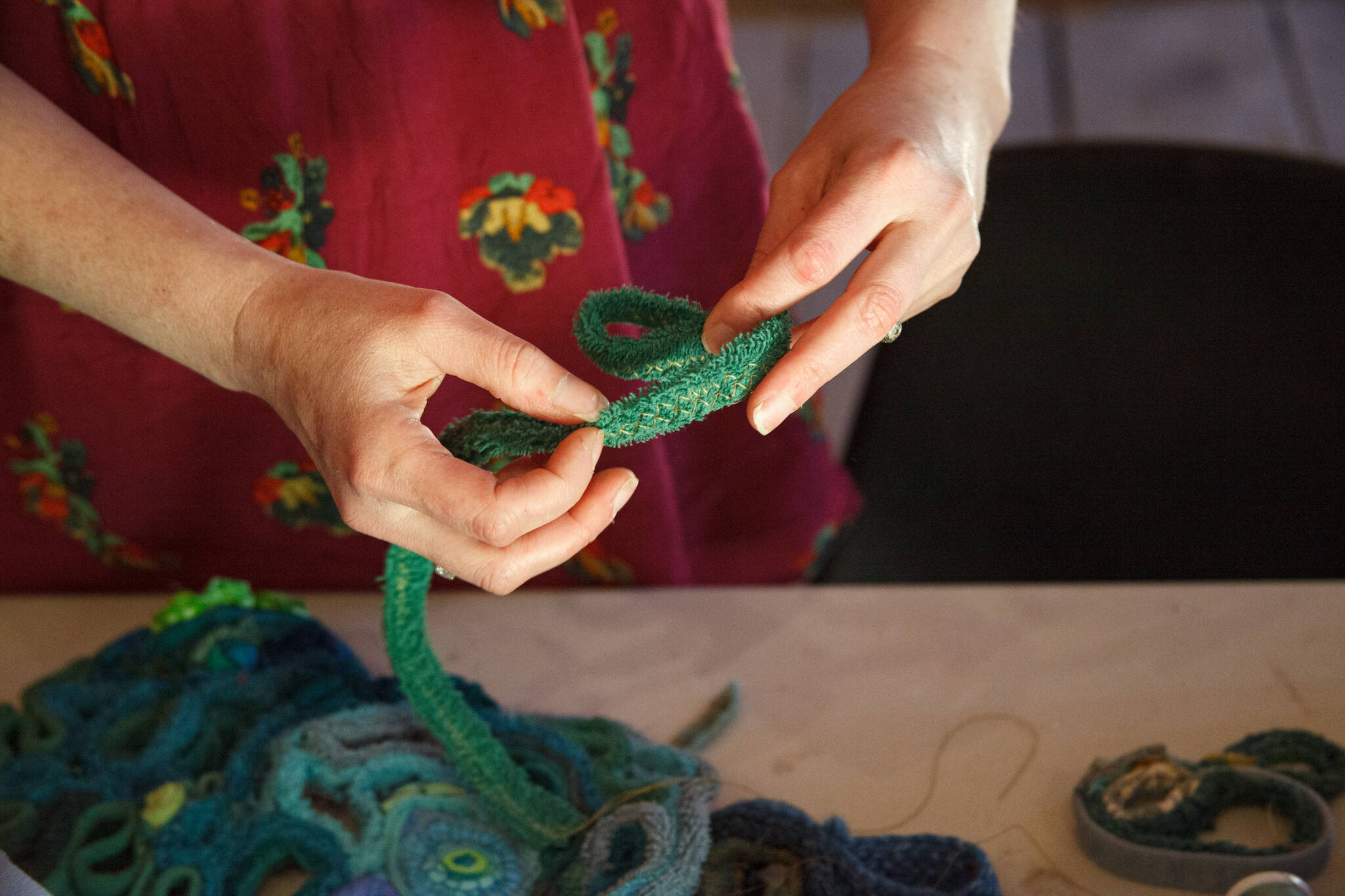 Amanda Triplett, Mary Olson Farm’s current Artist in Residence, explains the process of creating textile sculptures from scrap fabrics. Photo by Henry Stewart-Wood/Sound Publishing