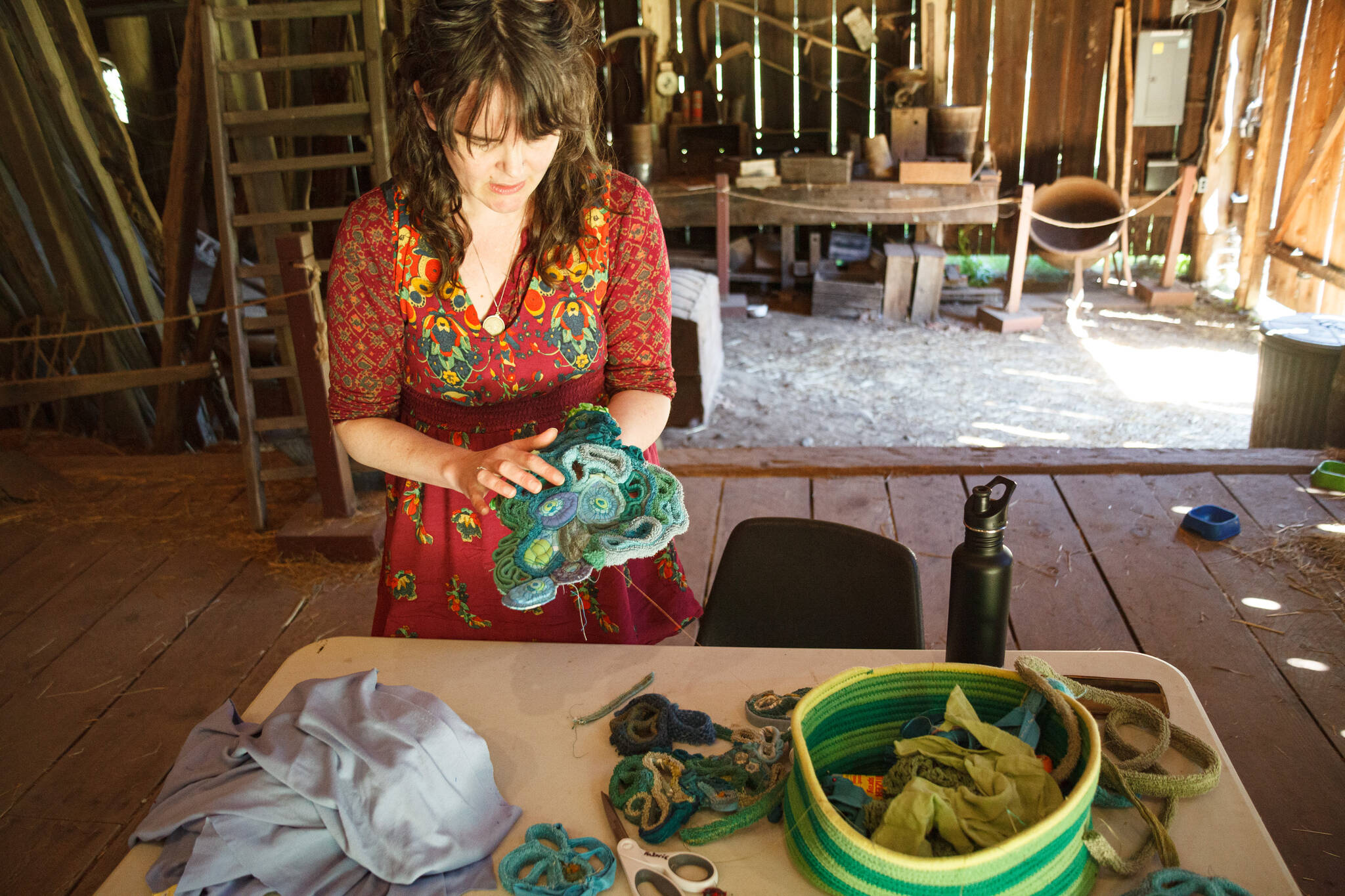 Amanda Triplett, Mary Olson Farm's current Artist in Residence, explains the process of creating textile sculptures from scrap fabrics. Photo by Henry Stewart-Wood/Sound Publishing
