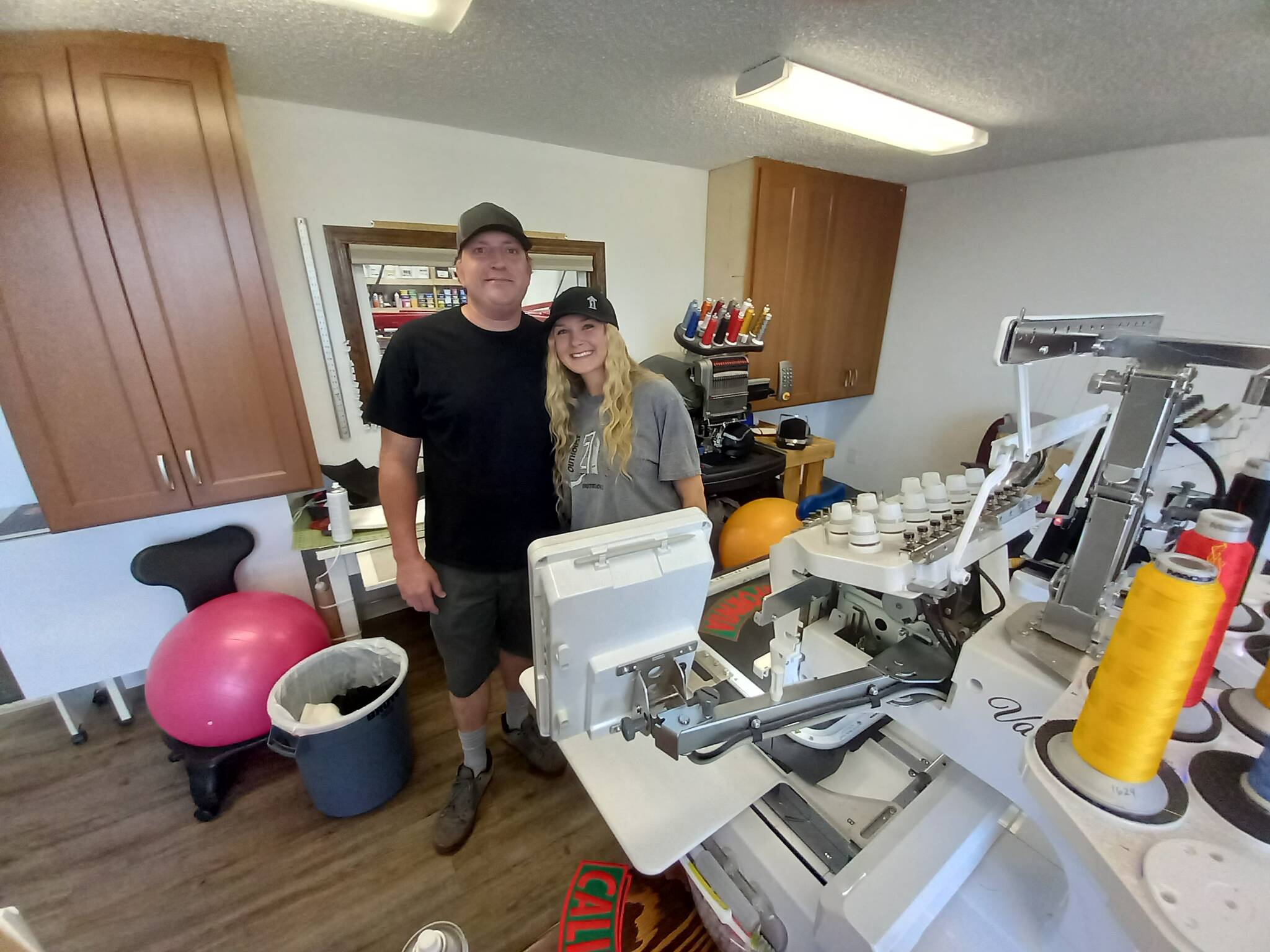 Jon Williams and his daughter, Courtney, run the highly successful family business, The Outhouse, the go-to-place for silk screening and embroidery in the area. Photo by Robert Whale, Auburn Reporter.