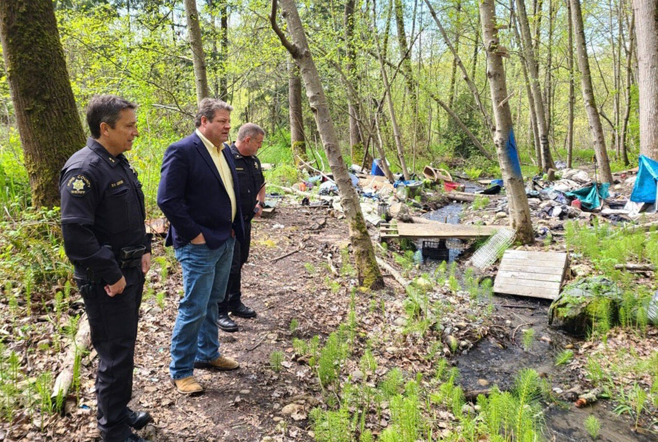 King County Councilmember Reagan Dunn and Sheriff’s Office deputies walk through a homeless encampment along the Green River between Kent and Auburn. COURTESY PHOTO, King County