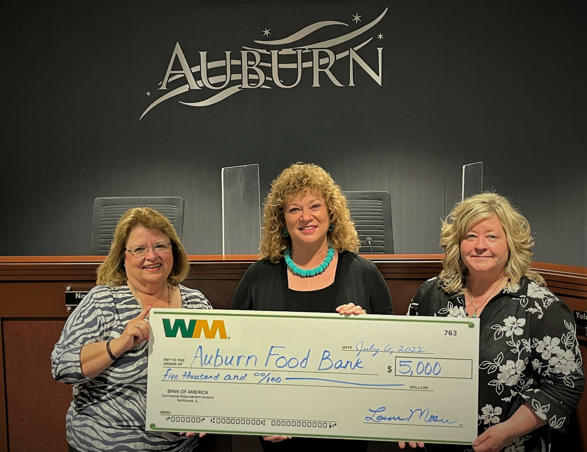Photo courtesy of Waste Management
(Left to right) Debbie Christian of the Auburn Food Bank, Auburn Mayor Nancy Backus and Laura Moser from Waste Management pose for a photo with the $5,000 check WM donated to the Auburn Food Bank.