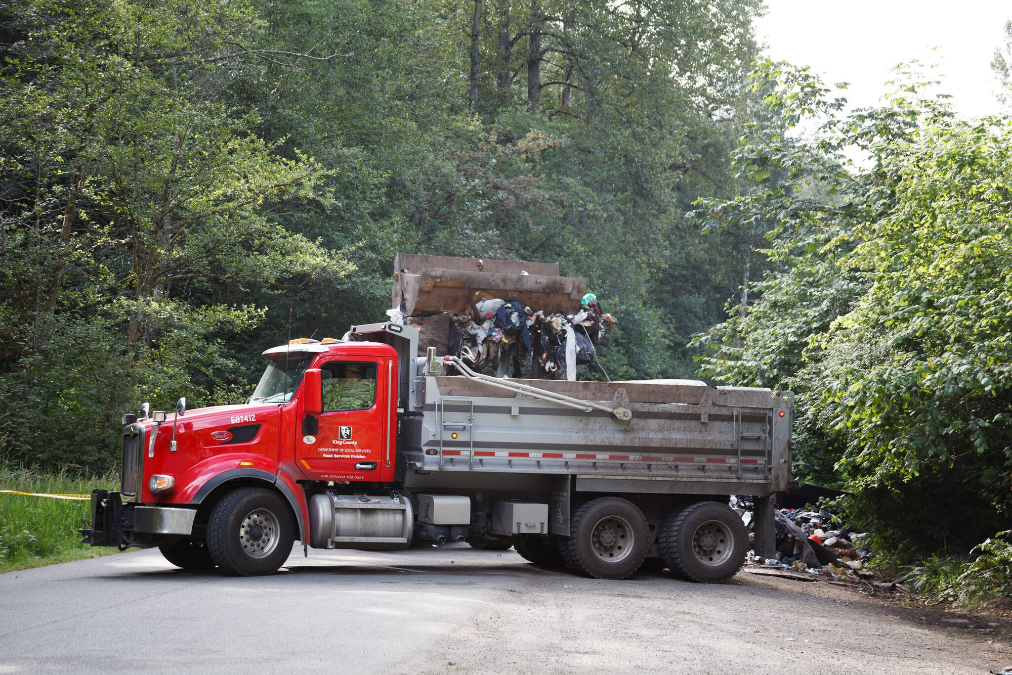 County workers cleaned trash and debris along the Green River Road in unincorporated King County. Henry Stewart-Wood/Sound Publishing