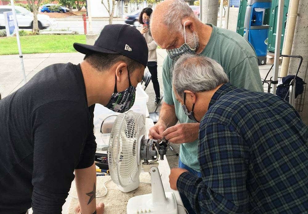 Photo courtesy of King County Solid Waste Division
Volunteer “fixers” attempt to repair a fan at one of King County’s 2021 repair events.