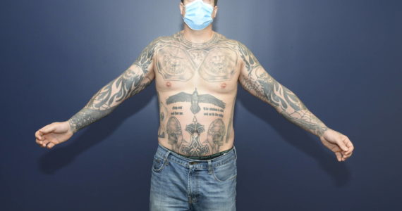Unredacted photo of Jeff Nelson’s tattoos recently released by Judge Nicole Gaines Phelps. Nelson has a quote by Fascist dictator Benito Mussolini just under his neckline. These photos were taken by the FBI after Nelson was charged with murder. Courtesy photo