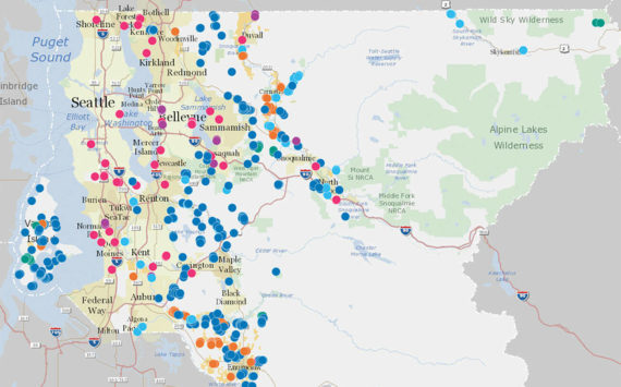 A map of various Land Conservation Initiative projects in King County. Dark blue spots represent natural lands; light blue, rivers; green, forests; pink, urban green space; purple, regional trails; and yellow, farmland. Map courtesy King County