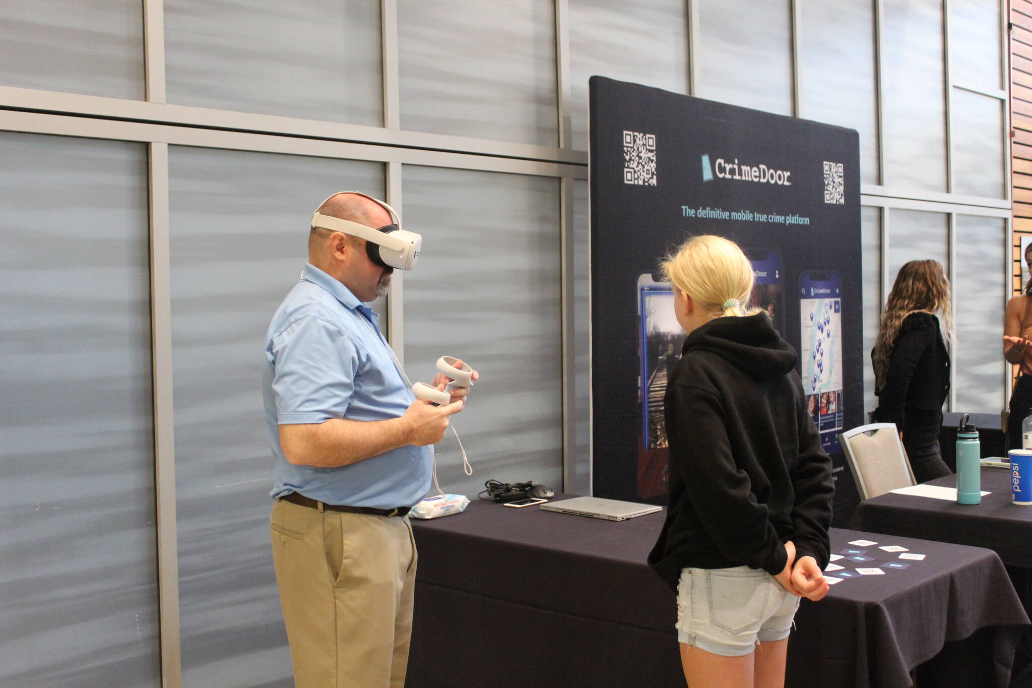 A guest is shown how to use augmented reality to explore the CrimeDoor app, a “definitive mobile true crime platform” that allows people to learn about and explore the sites and stories of true crime cases. Photo by Bailey Jo Josie/Sound Publishing.