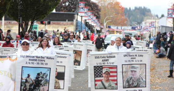 Photo by Kristy Pachciarz, City of Auburn
At the 2022 Veterans Parade and Observance, marchers display the images and names of veterans who gave the “last, full measure of devotion” to their nation in battle.