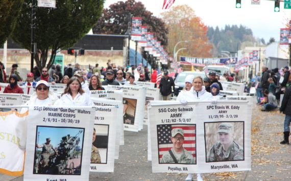 Photo by Kristy Pachciarz, City of Auburn
At the 2022 Veterans Parade and Observance, marchers display the images and names of veterans who gave the “last, full measure of devotion” to their nation in battle.