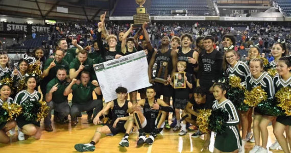Photo courtesy of Auburn High School basketball.
The Auburn High School boys basketball team poses for a photo after winning the state championship game against Rainier Beach last season.