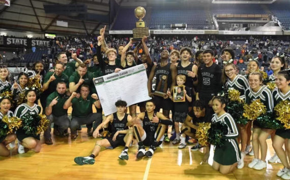 Photo courtesy of Auburn High School basketball.
The Auburn High School boys basketball team poses for a photo after winning the state championship game against Rainier Beach last season.
