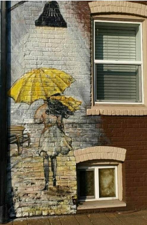 This eye-catching mural of a girl under umbrella graces the outer brick wall of G Street Legal on A St. SE.