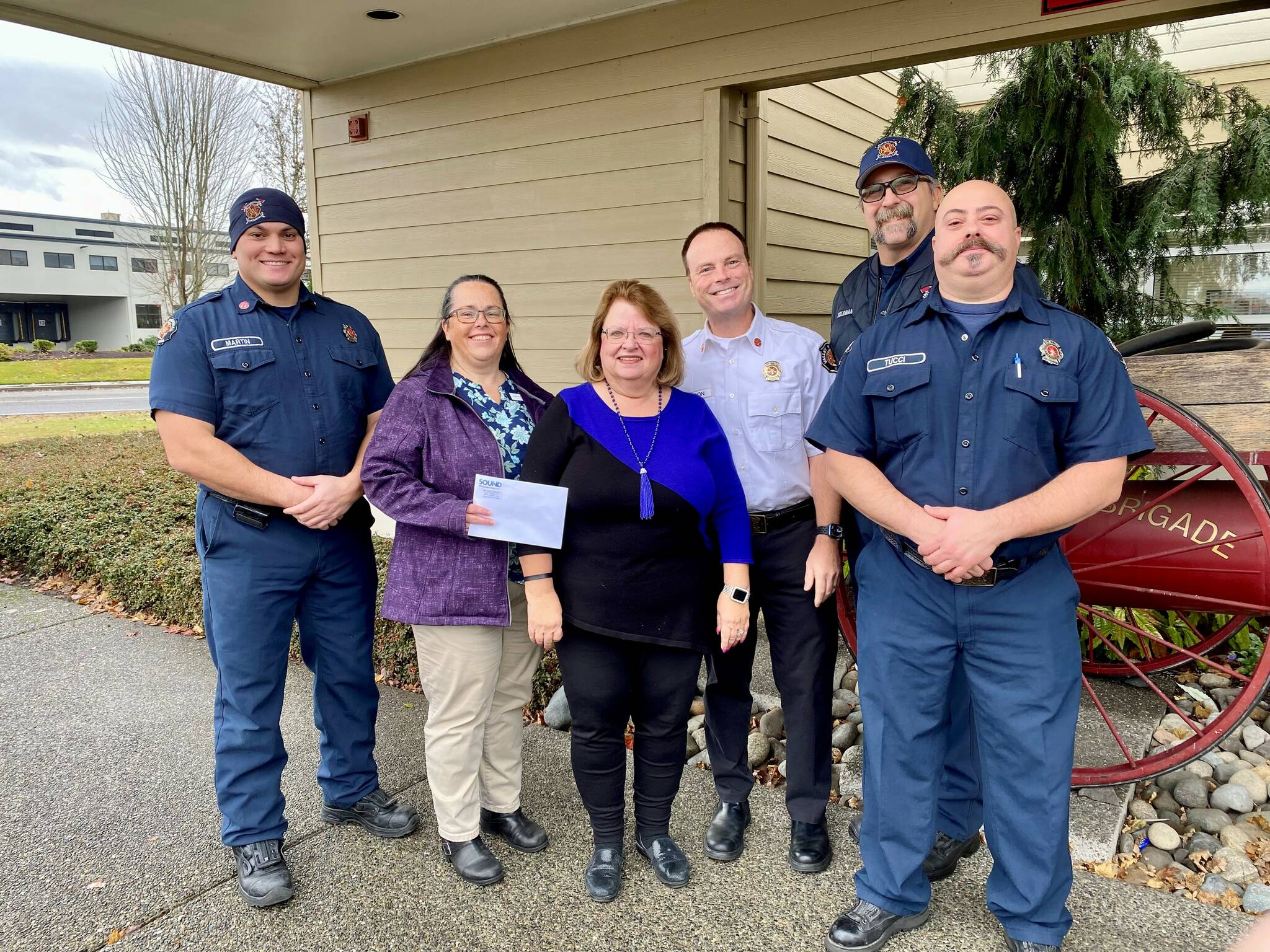 The Auburn Reporter donated some of the proceeds from September’s Local Heroes feature page to the Auburn Food Bank in honor of the Valley Regional Fire Authority. Pictured from left to right: Captain Aaron Martin, Laura Theimer of the Auburn Reporter, Debbie Christian of the Auburn Food Bank, Fire Chief Brad Thompson, Firefighter Tim Coleman, and Firefighter Ross Tucci. Courtesy photo