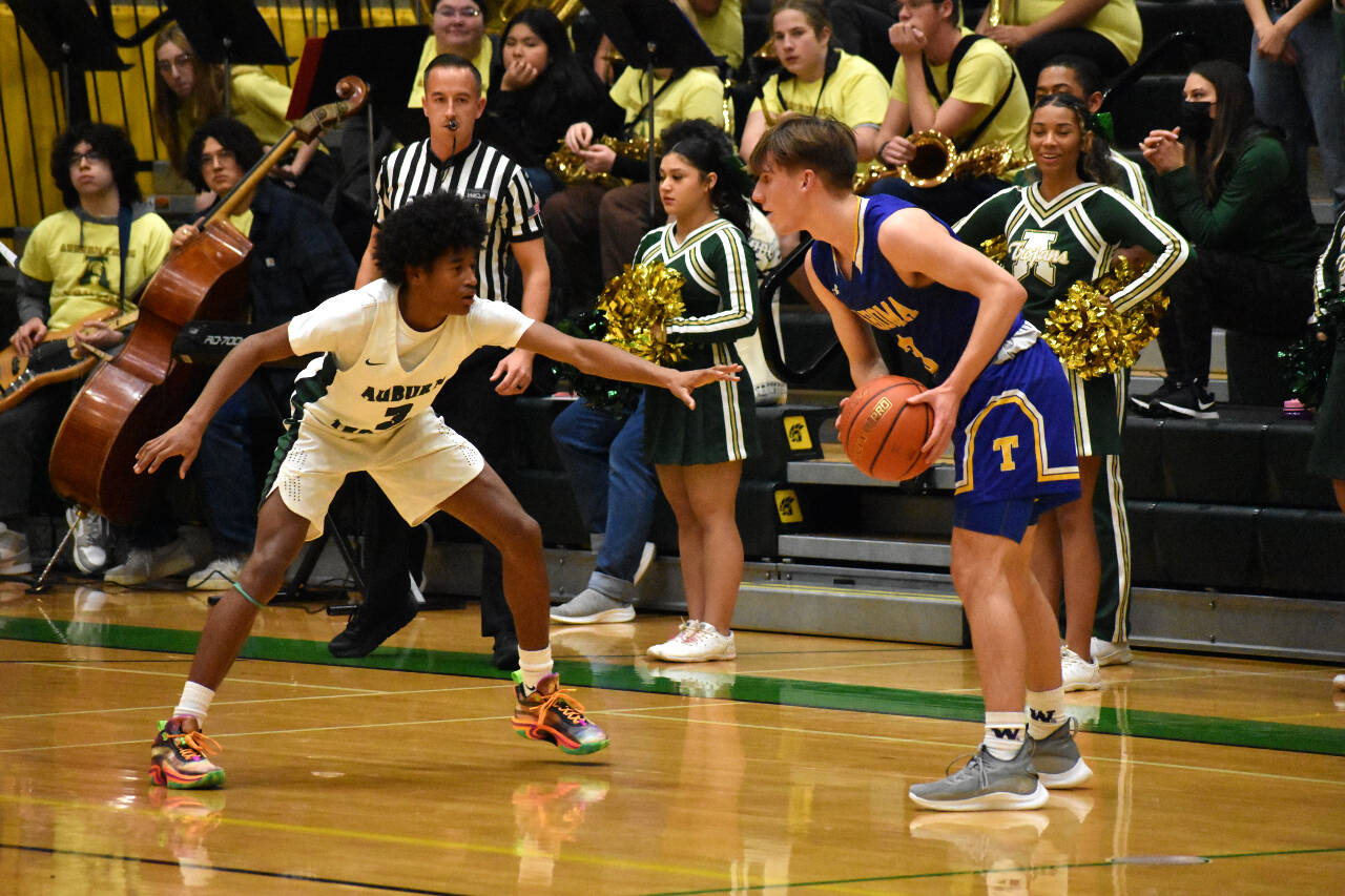 Trojan sophomore Jaylen Petty looks to lockdown Tahoma senior Kevin Williams.