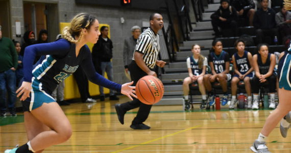 Auburn Riverside’s Ava Berry takes the ball up the floor against the Trojans.