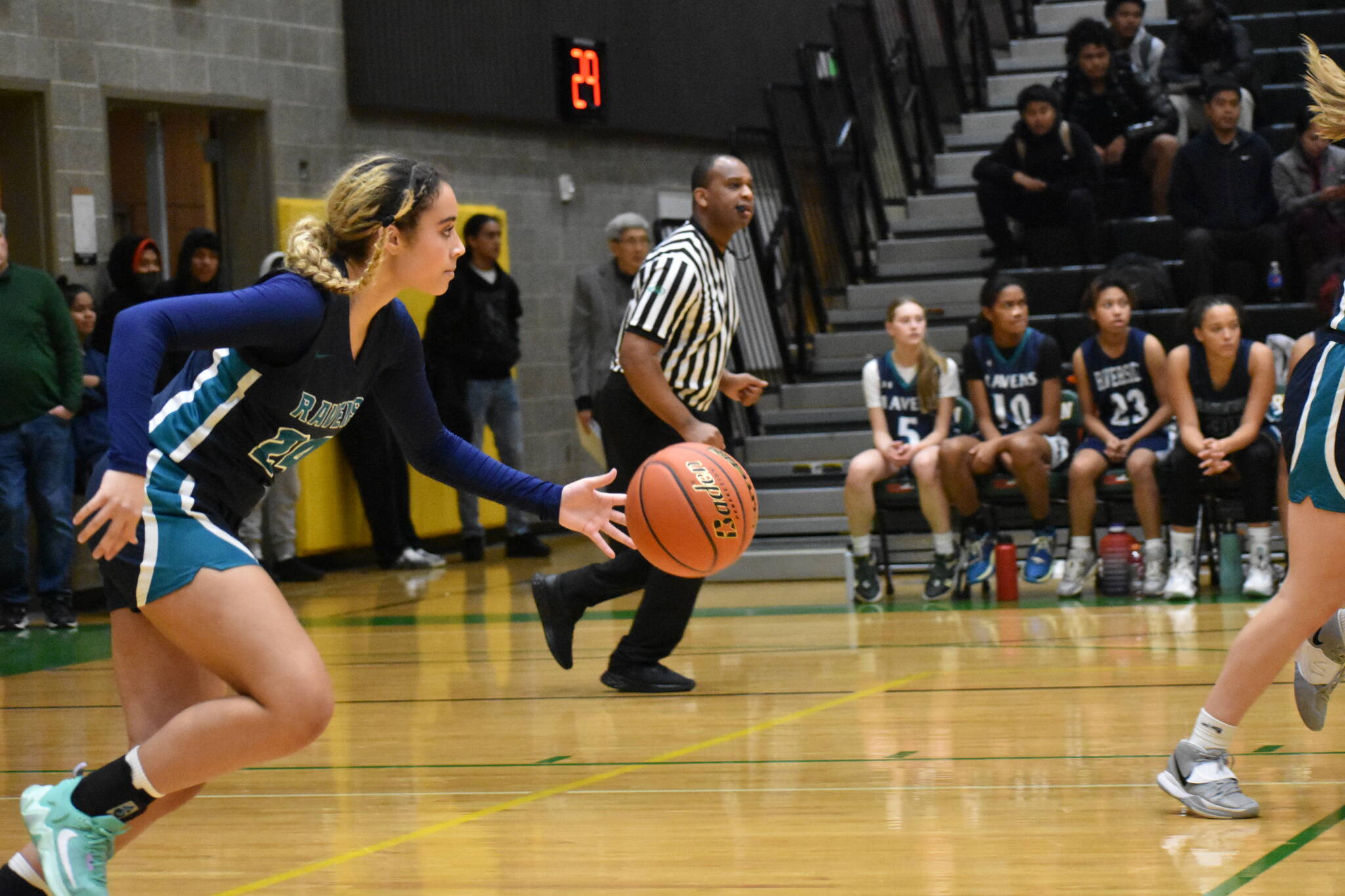 Auburn Riverside’s Ava Berry takes the ball up the floor against the Trojans.