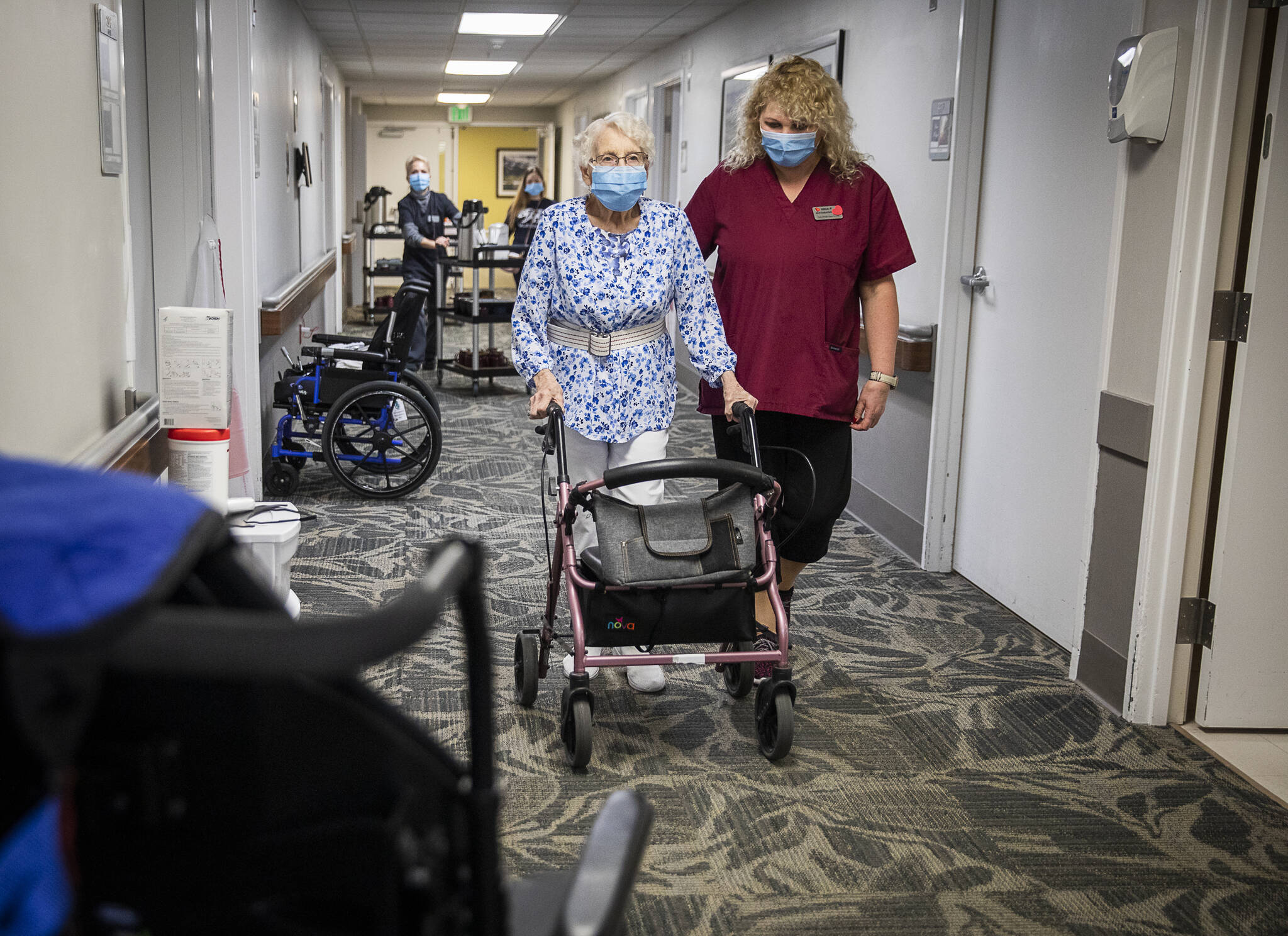 Olivia Vanni / The Herald
CNA Nina Prigodich, goes through restorative exercises with long term care patient Betty Long, 86, at View Ridge Care Center in Everett on Friday.