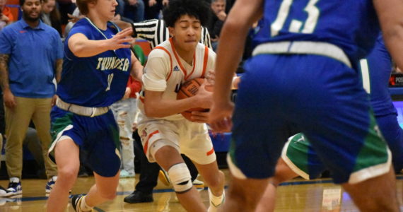 Jamaal Elliott drives to basket during the state playoff game against Mountain View. Photo Credit: Ben Ray/The Reporter