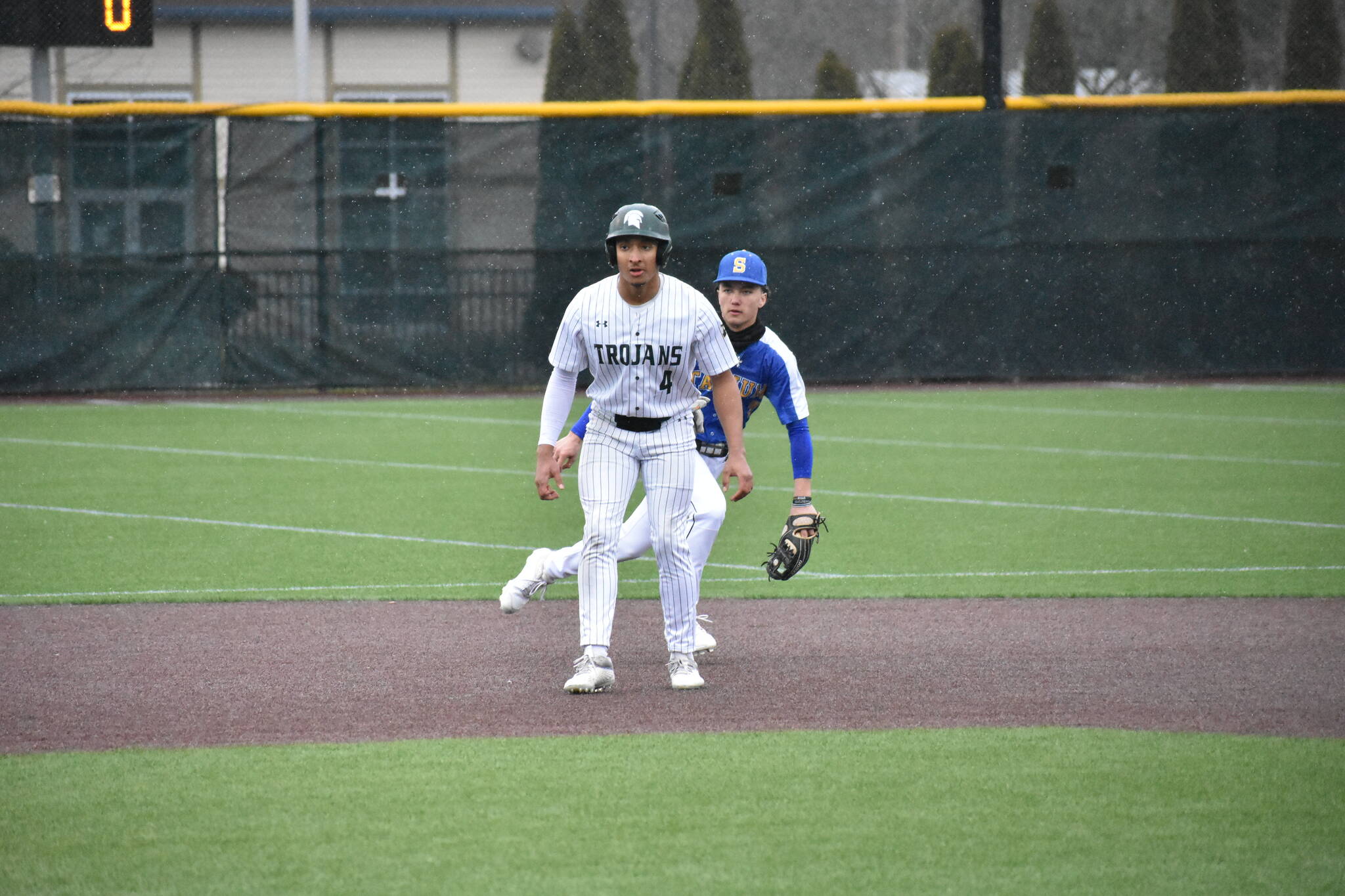 Trojan senior Amari Goodfellow takes a lead after his RBI single in the first. Ben Ray / The Reporter