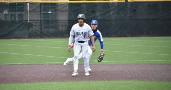 Trojan senior Amari Goodfellow takes a lead after his RBI single in the first. Ben Ray / The Reporter