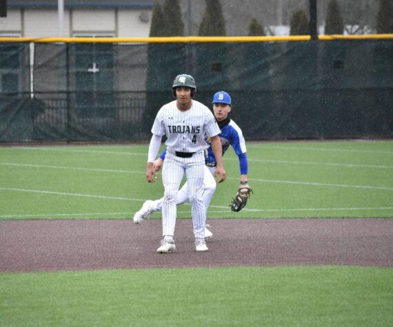 Trojan senior Amari Goodfellow takes a lead after his RBI single in the first. Ben Ray / The Reporter