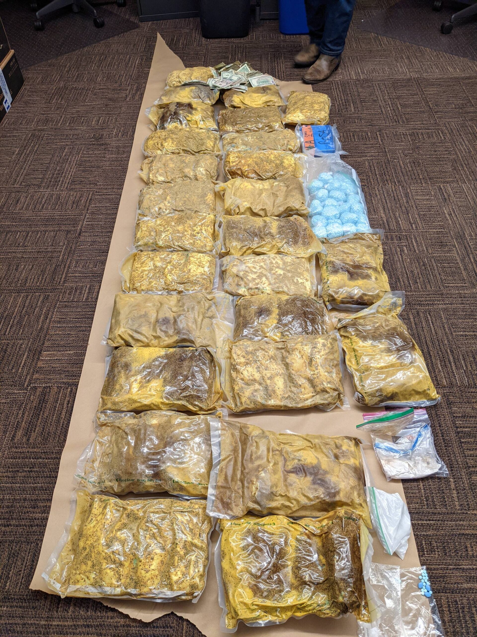 Approximately 104 pounds of methamphetamine, more than 2 pounds of suspected fentanyl powder, and more than 20,000 suspected fentanyl pills seized by law enforcement. (Courtesy of the Department of Justice)