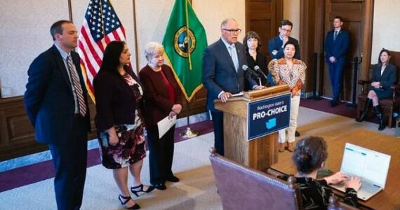 From left to right: Rep. Marcus Riccelli, Sen. Manka Dhingra, Sen. Karen Keiser, Gov. Jay Inslee, Rep. Jessica Bateman, Rep. My-Linh Thai and AG Bob Ferguson. (Courtesy photo)