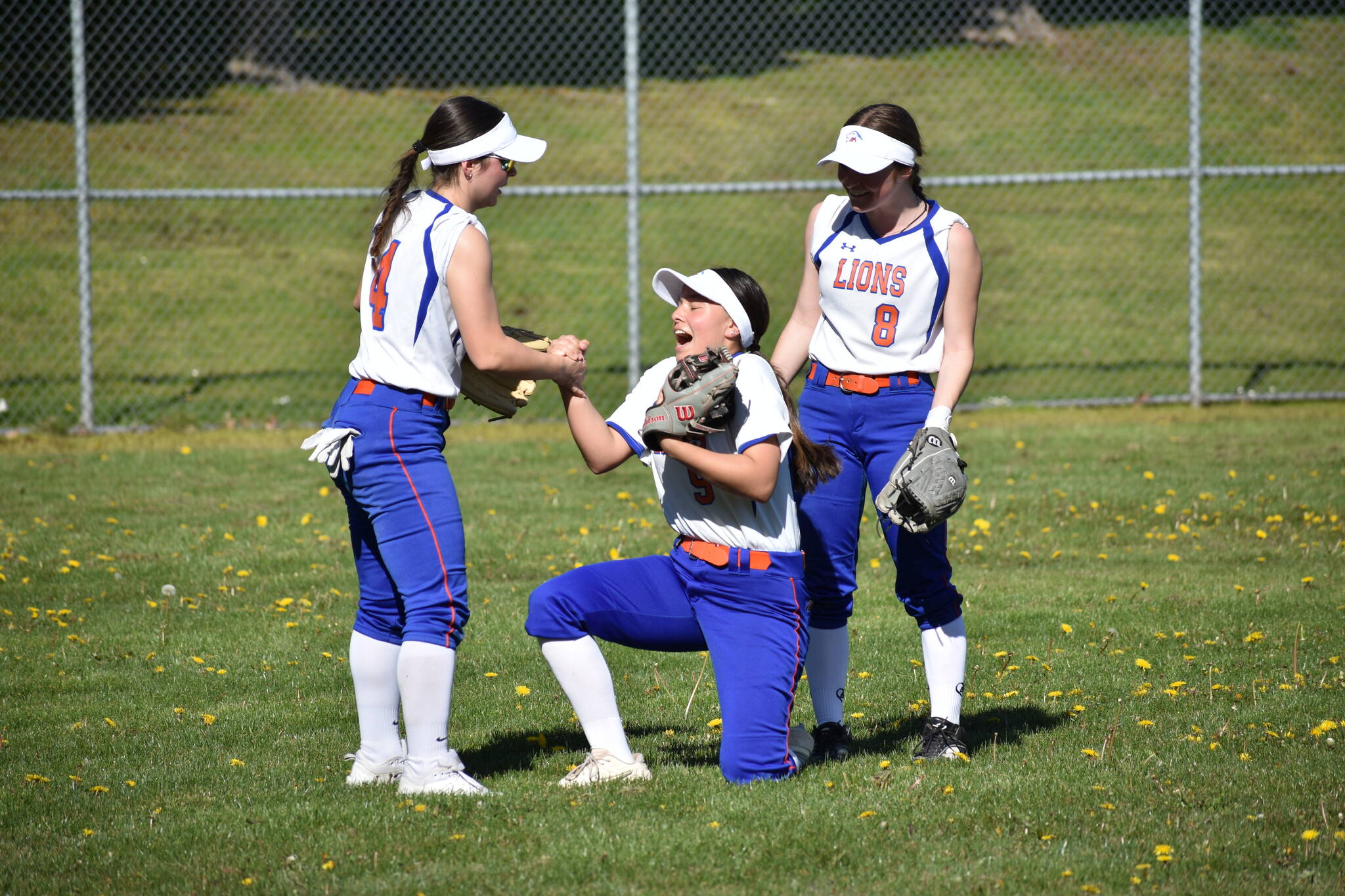 After a close call in the outfield Taylor Minton was helped by her teammates Lily Mcmullen and Shelby Mason. Ben Ray / The Reporter
