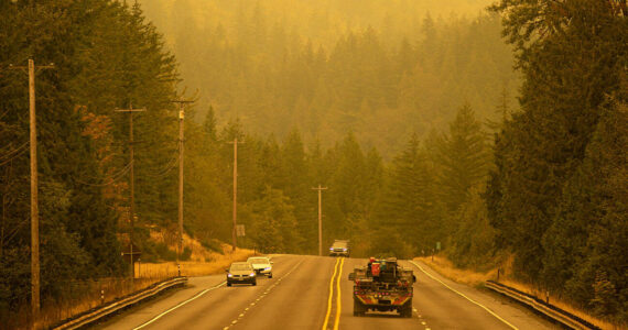 An emergency fire vehicle heads past a barricade and towards Index as numerous agencies attempt to contain the Bolt Creek Fire on Saturday, Sep. 10, 2022, on U.S. Highway 2 near Index, Washington. (Ryan Berry / The Herald)