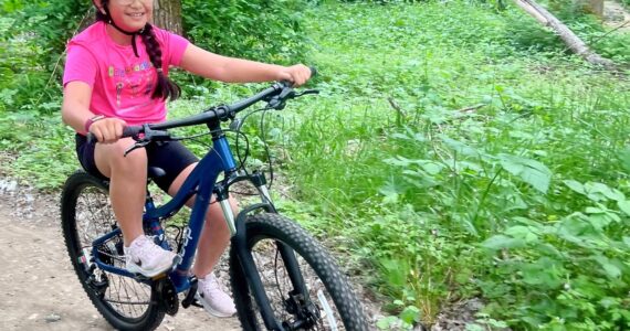 A girl tries out the Cedar Lanes bike trail in Auburn before its opening. Photo courtesy of Auburn Parks, Arts and Recreation.