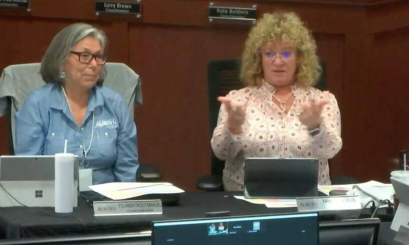 Pictured: Auburn City Councilmember Yolanda Trout-Manuel, left, listens to Auburn Mayor Nancy Backus at the recent council meeting. (Screenshot from YouTube)