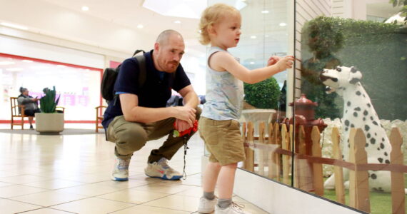 Photo by Keelin Everly-Lang / Sound Publishing
Jared Gloster and son Gavin enjoy a display of life size toy dogs at the Commons Mall in Federal Way.