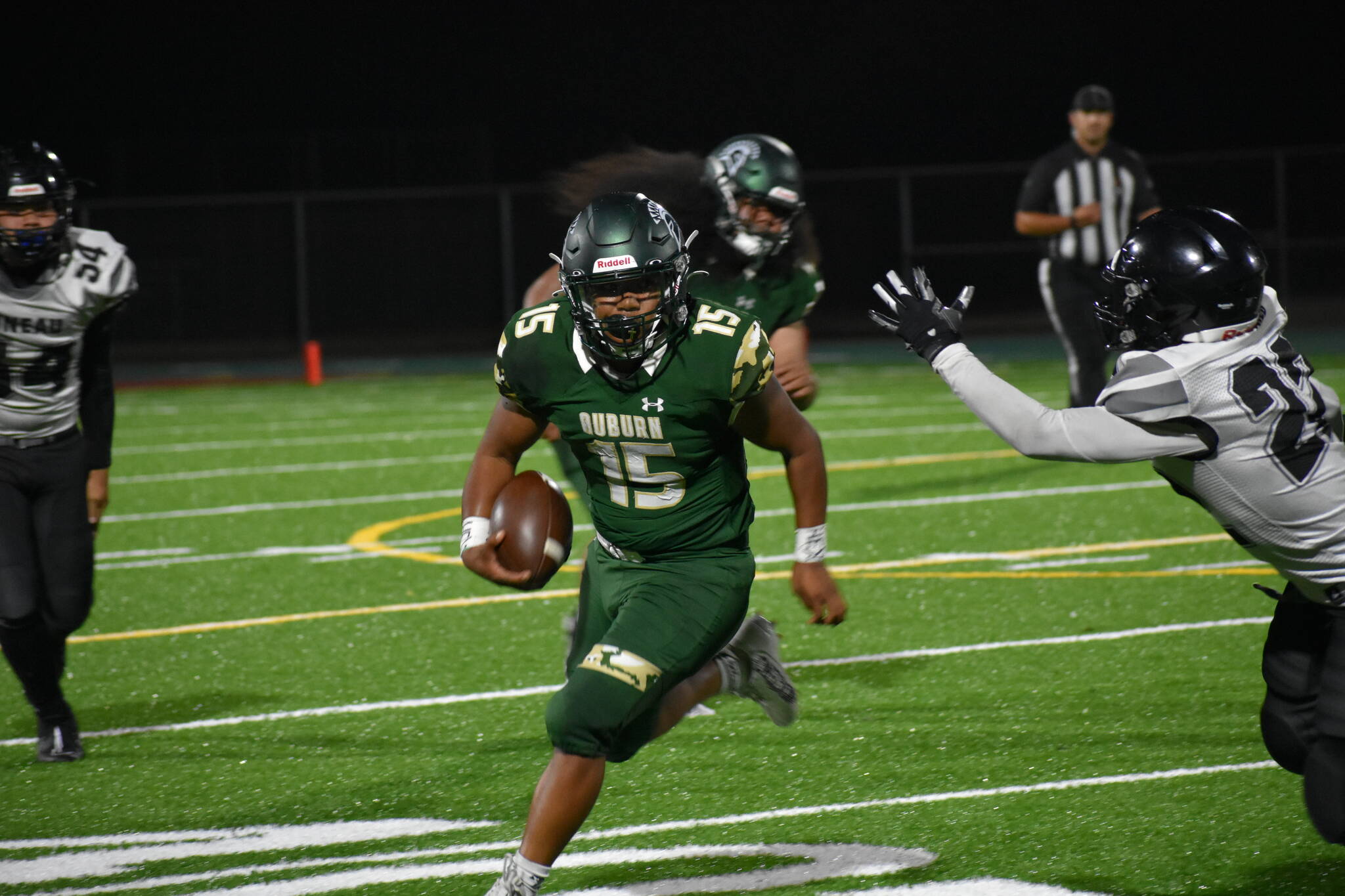 Trojan QB DJ Bielza tries to avoid a defender. Ben Ray / The Reporter