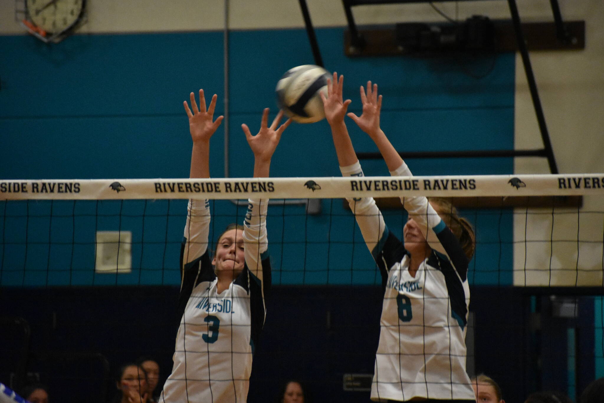 Senior Sydney Priebe and Kate Danielson go up for a block. Ben Ray/ The Reporter