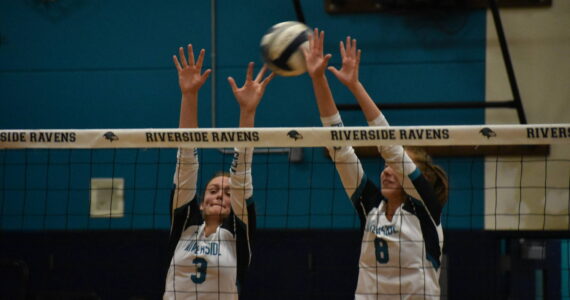 Senior Sydney Priebe and Kate Danielson go up for a block. Ben Ray/ The Reporter