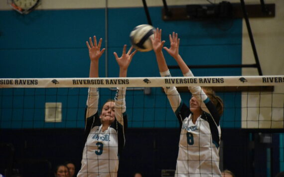 Senior Sydney Priebe and Kate Danielson go up for a block. Ben Ray/ The Reporter