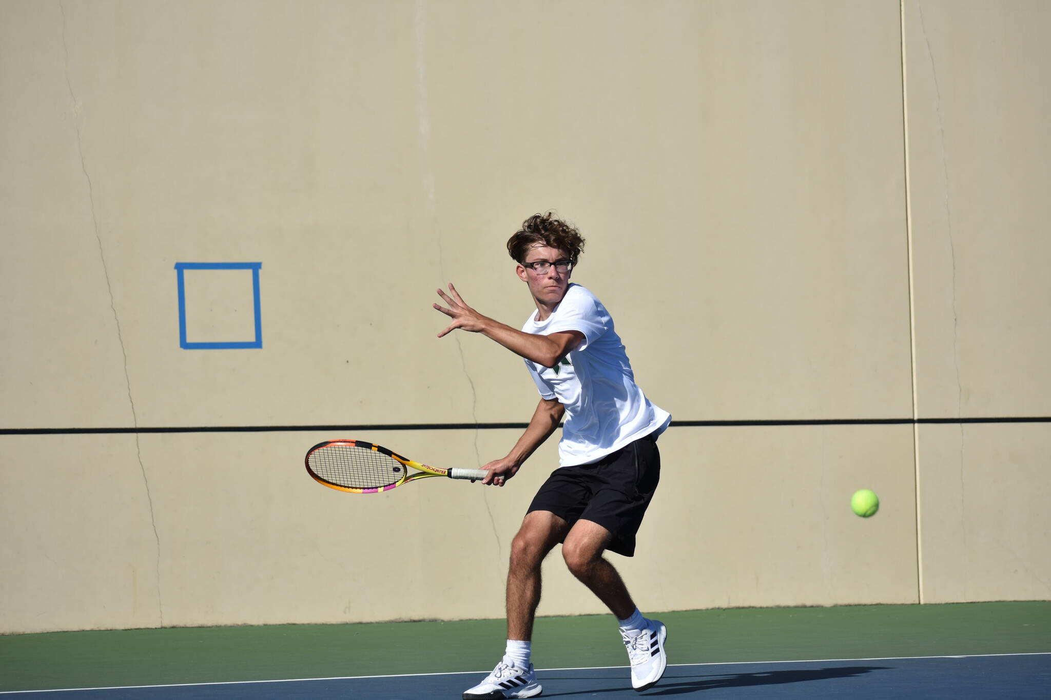 Serhiy Martyniuk approaches a low bouncing ball in the first set of his match. Ben Ray / The Reporter