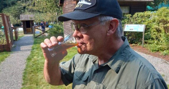 Kent resident and U.S. Navy veteran Karey Wise relishes a long pull on his Octoberfest Märchen at Auburn's Hops and Crops beer and music festival out at Mary Olson Farm on Sept. 16. Photo by Robert Whale, Auburn Reporter.