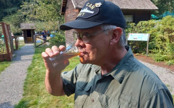 Kent resident and U.S. Navy veteran Karey Wise relishes a long pull on his Octoberfest Märchen at Auburn's Hops and Crops beer and music festival out at Mary Olson Farm on Sept. 16. Photo by Robert Whale, Auburn Reporter.