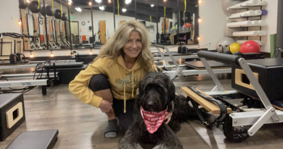 Shelia Cowart at Longevita Pilates and Yoga Studio with her dog. Photo Courtesy of Shelia Cowart.